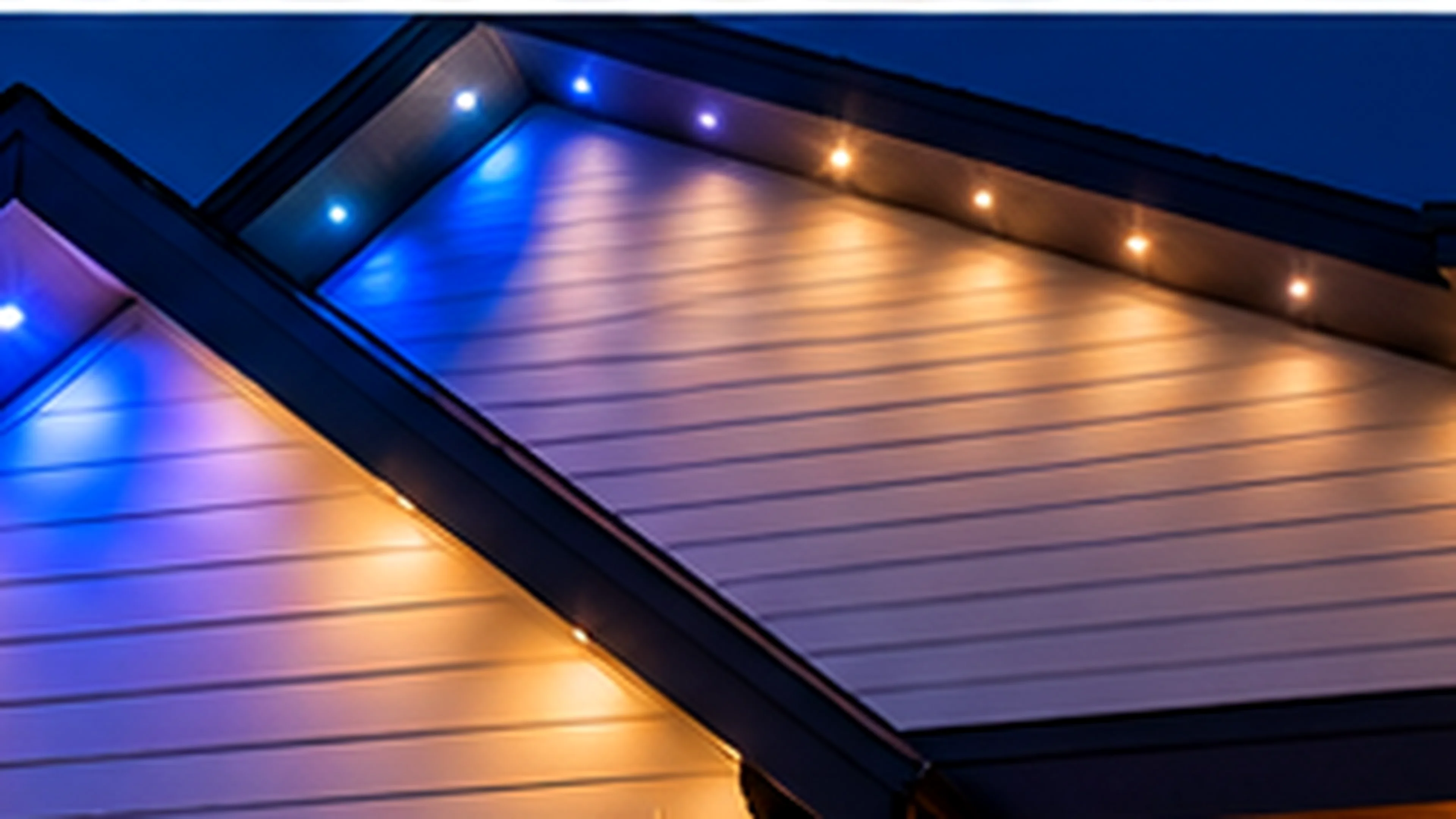 Blue programmable LED accent lighting along a residential roofline and soffits